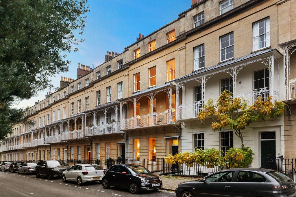Georgian terrace with ornate ironwork balconies on a Bristol street at dusk